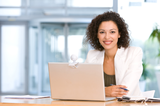 Attractive business woman working on laptop