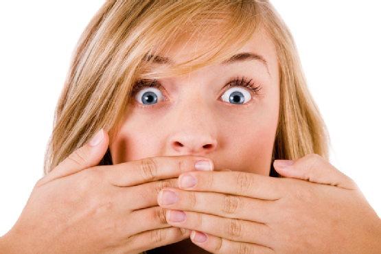 Closeup of young women covering her mouth with both hands